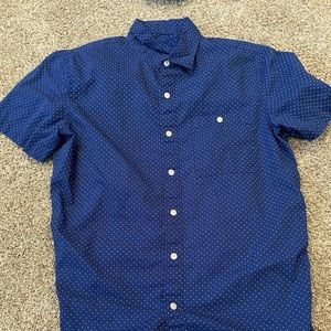 Blue button up shirt with white dots